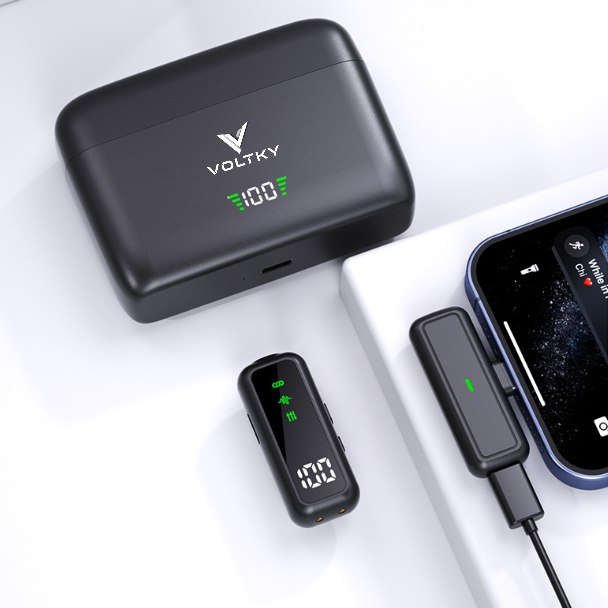 Black lavalier microphone device with digital display on a white surface, featuring the brand 'VOLTKY'.